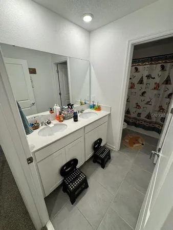 a bathroom with a sink toilet and mirror
