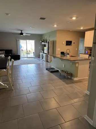 a large white kitchen with lots of counter space and glass door