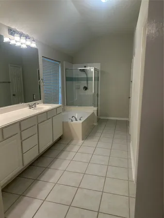 an empty room with a fireplace and windows
