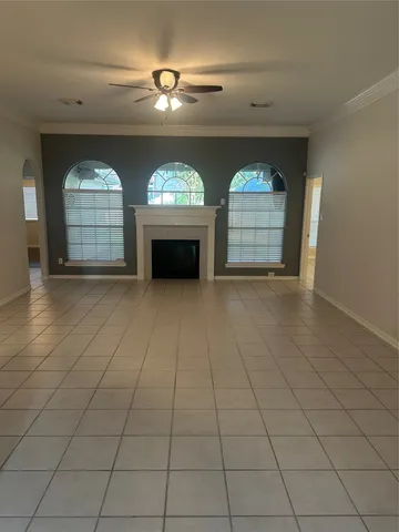 an empty room with a fireplace and windows