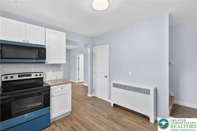 a kitchen with stainless steel appliances a stove microwave and cabinets