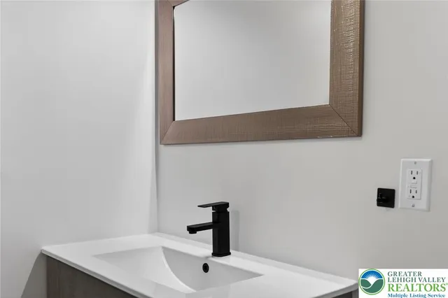 a bathroom with a sink and a mirror