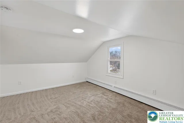 a view of an empty room and a window