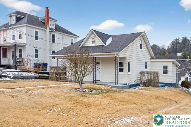 a view of a house with snow on the road