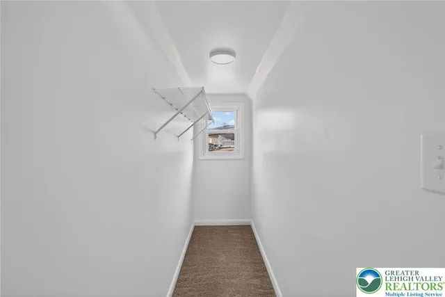 a view of a hallway with a white walls