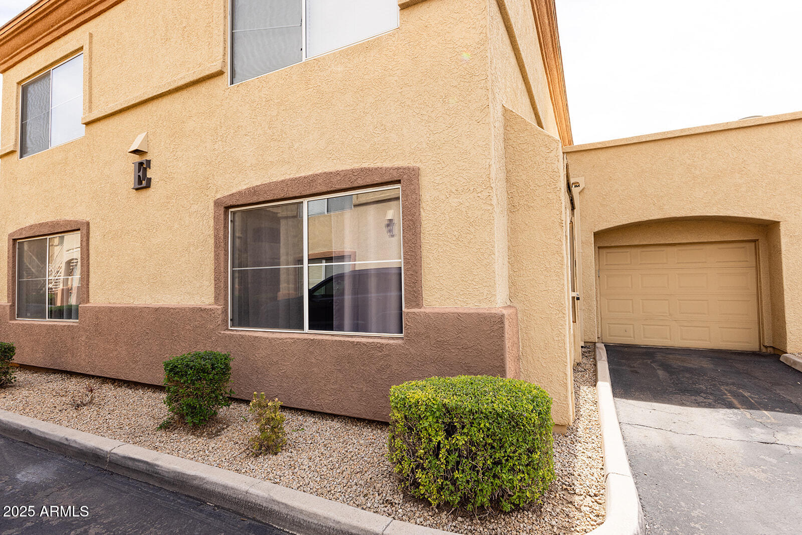 2134 East Broadway Road, Unit 1016 Tempe, AZ 85282 - Photo 3 of 33 a front view of a house with a yard
