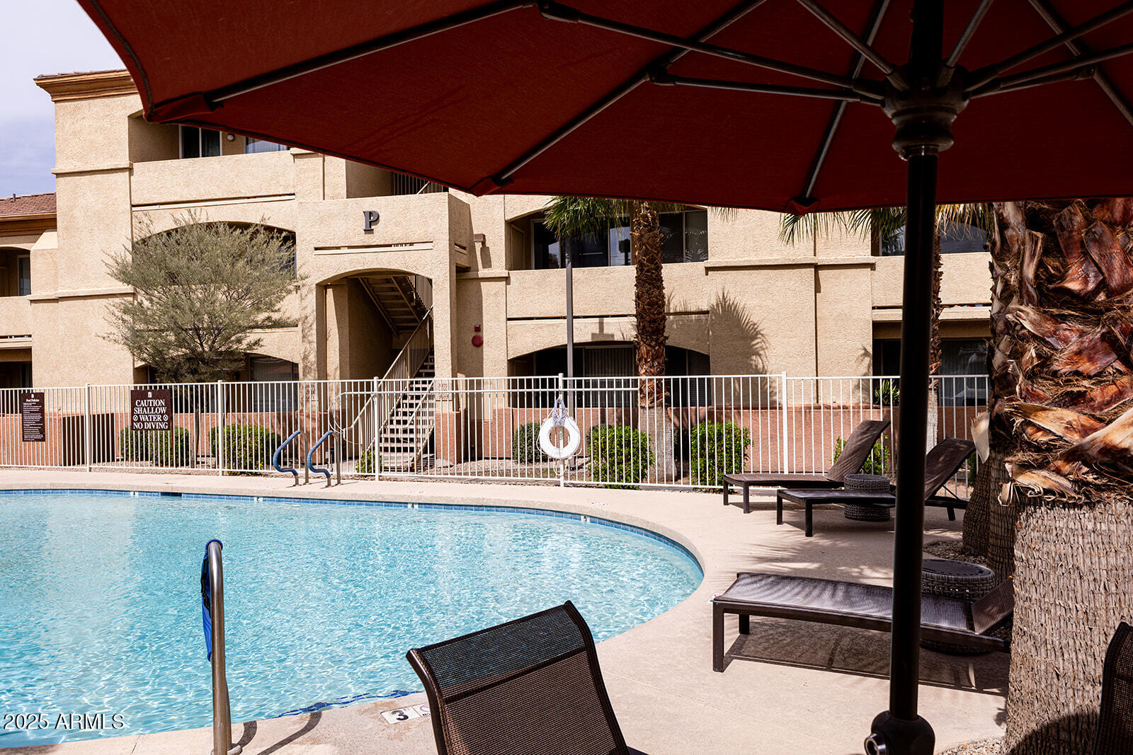 2134 East Broadway Road, Unit 1016 Tempe, AZ 85282 - Photo 32 of 33 a view of a patio with table and chairs under an umbrella