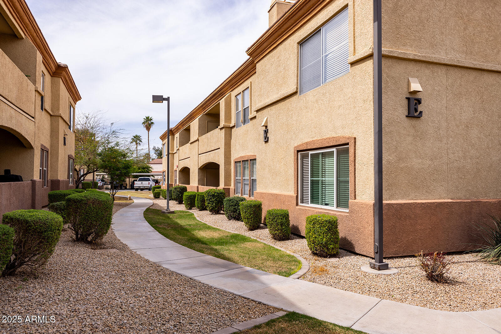 2134 East Broadway Road, Unit 1016 Tempe, AZ 85282 - Photo 4 of 33 a view of a white house with couches chairs and a fire pit