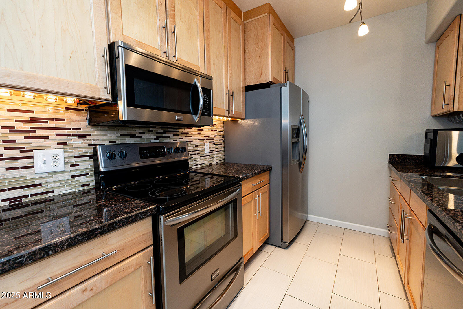 2134 East Broadway Road, Unit 1016 Tempe, AZ 85282 - Photo 5 of 33 a kitchen with stainless steel appliances and granite countertop a stove top oven