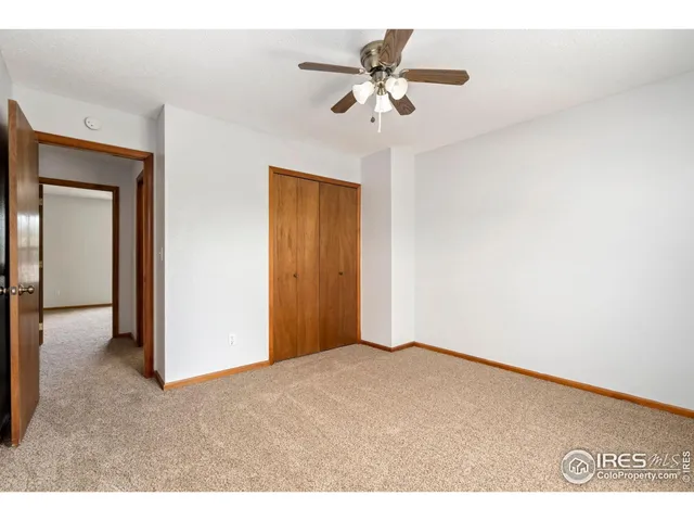 a view of an empty room with a ceiling fan