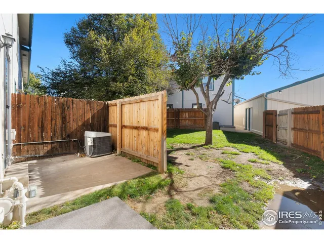 a view of a backyard with wooden fence