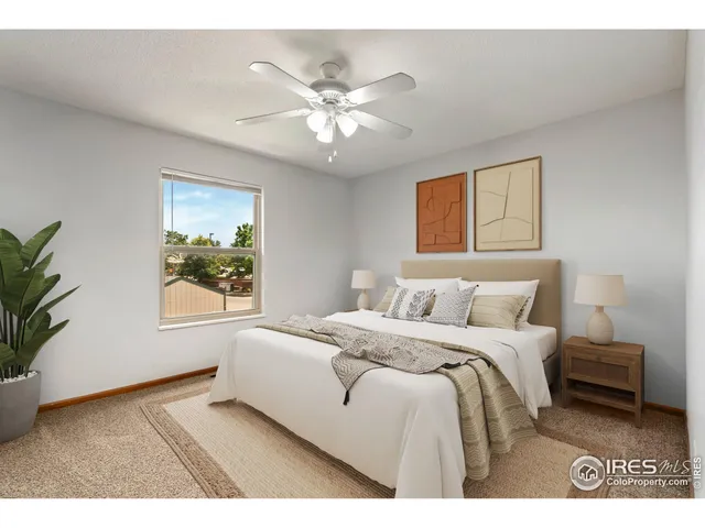 a bedroom with a large bed and a window
