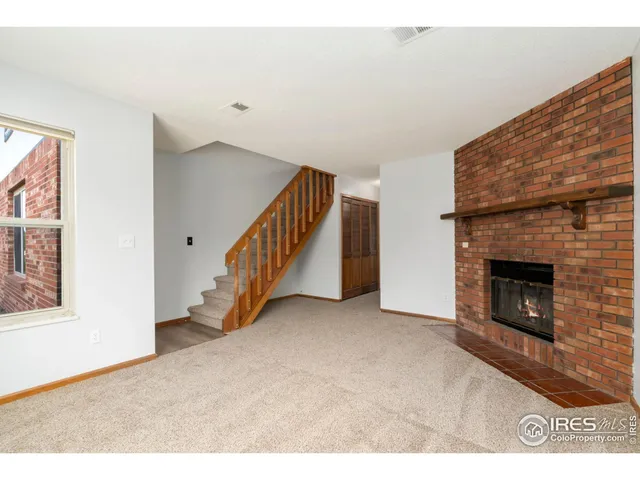 a view of empty room with fireplace