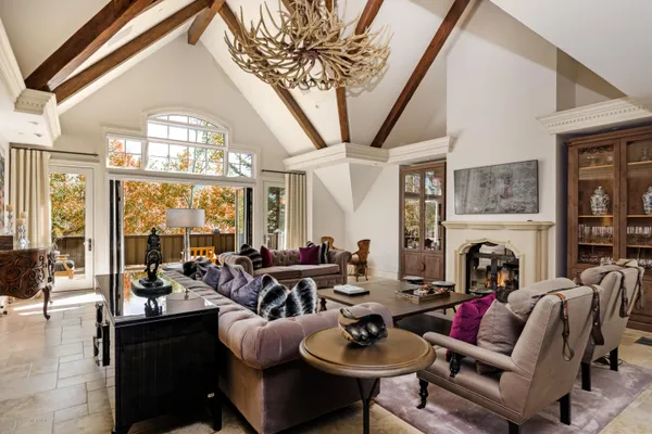 a living room with furniture fireplace and a large window