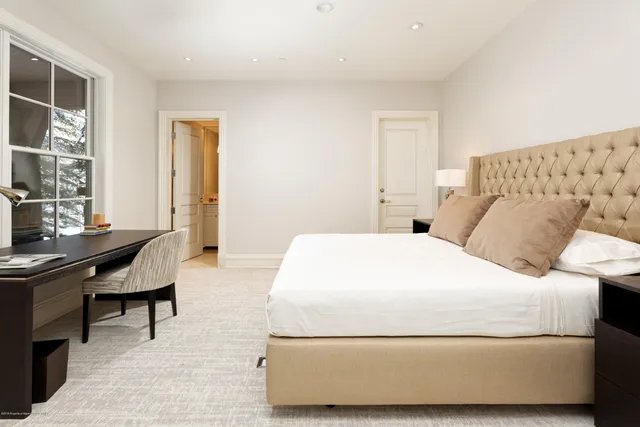 a bedroom with a bed and a desk