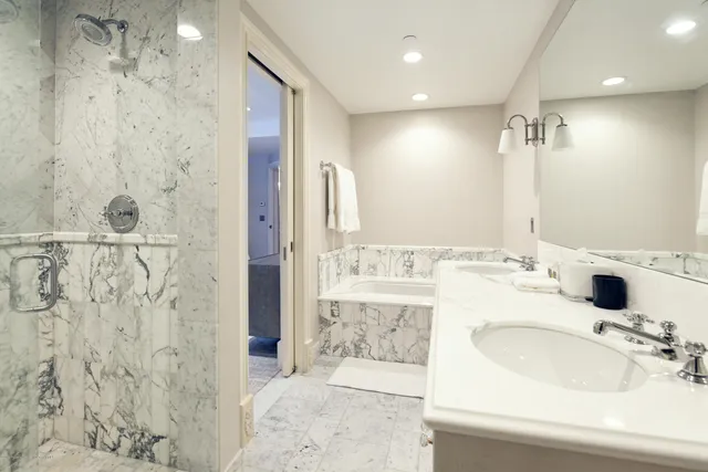 a bathroom with a double vanity sink mirror and shower