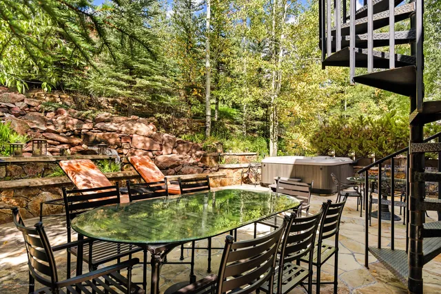 a balcony with table and chairs