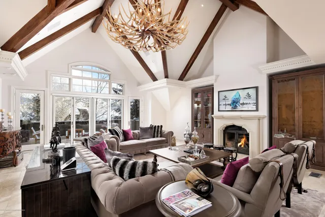 a living room with furniture fireplace and a large window