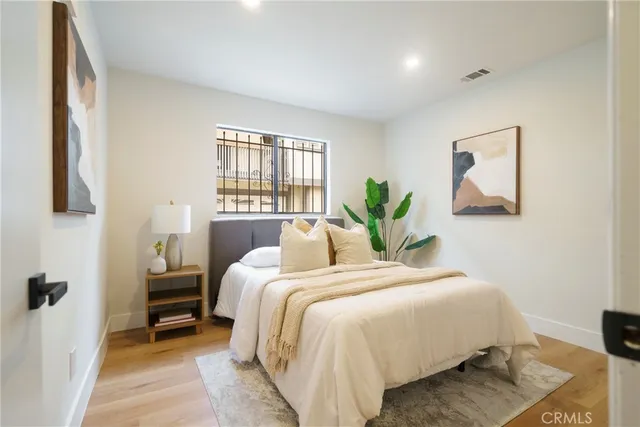 a bedroom with a bed and a painting on the wall