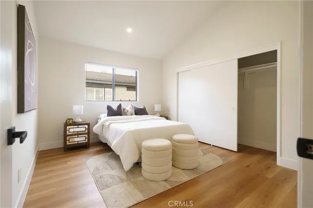 a bedroom with a bed and wooden floor