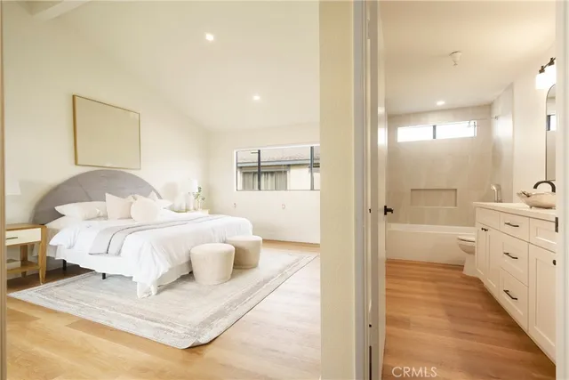 a bedroom with a bed and wooden floor