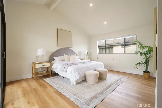 a bedroom with a bed and a painting on the wall