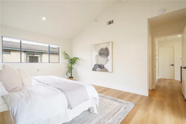 a bedroom with a bed and a large window