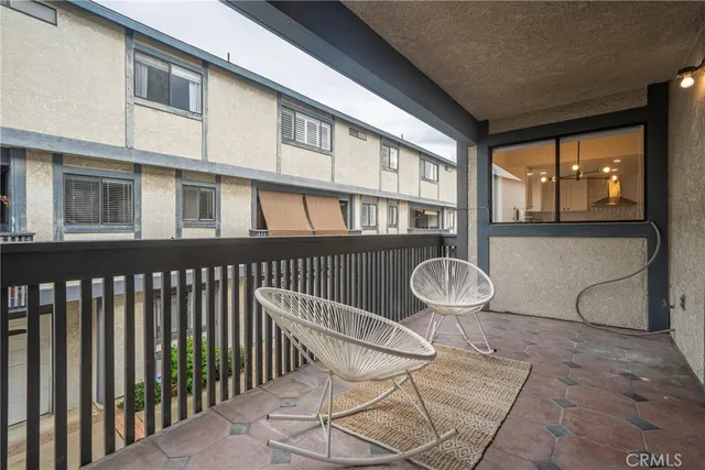 a view of a chair and table in the balcony