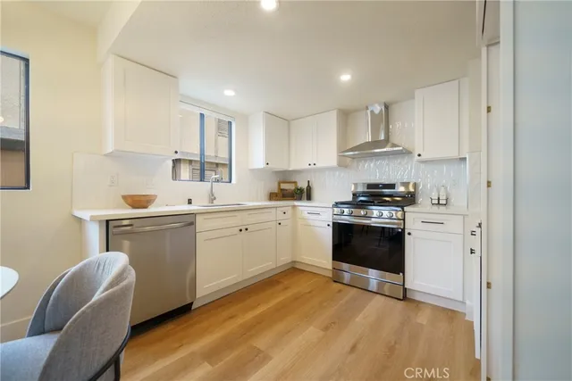 a kitchen with a white cabinets and white appliances