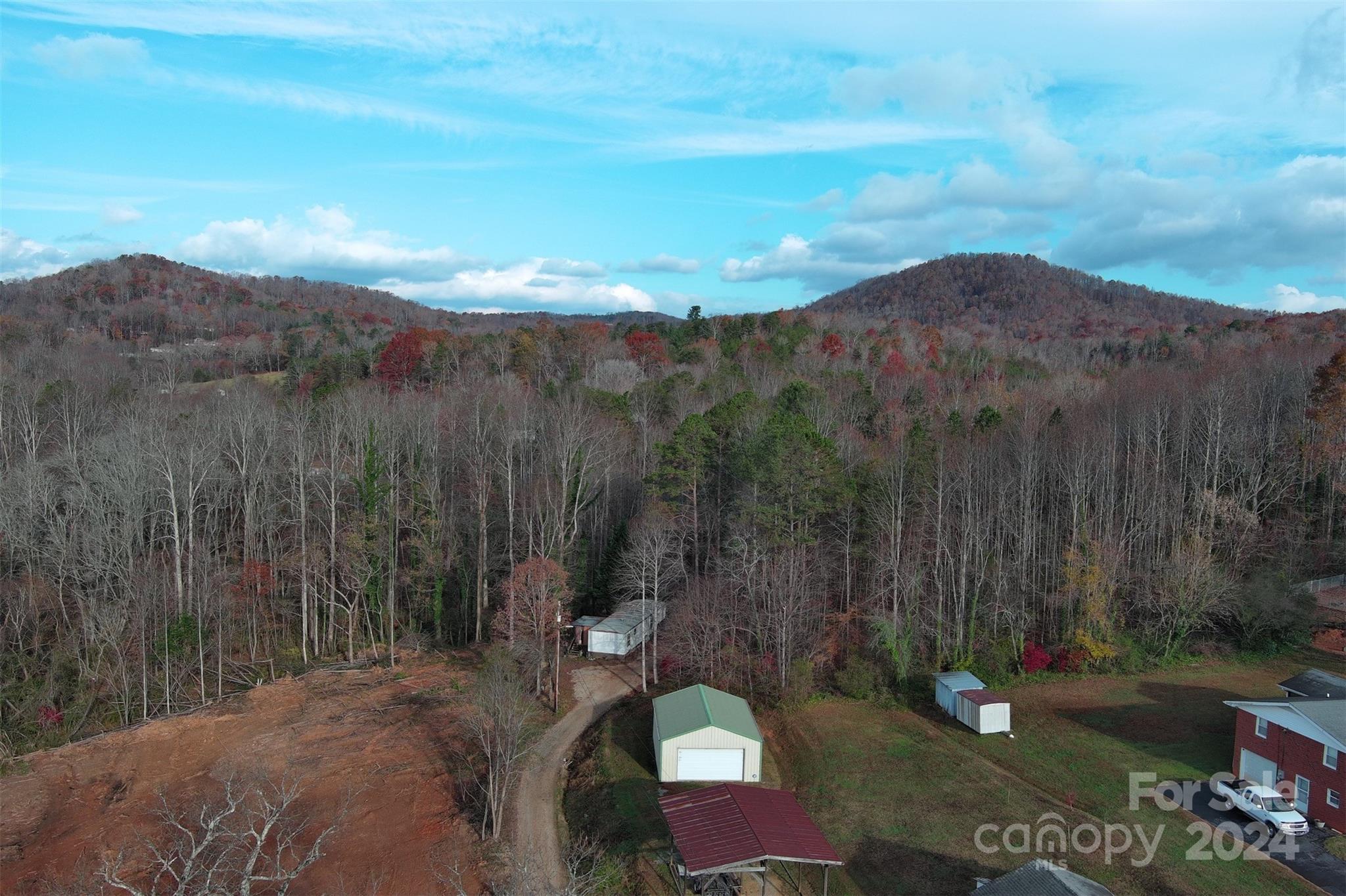 139 Pleasant Hill Road Marion, NC 28752 - Photo 4 of 18 a view of a city with lush green forest