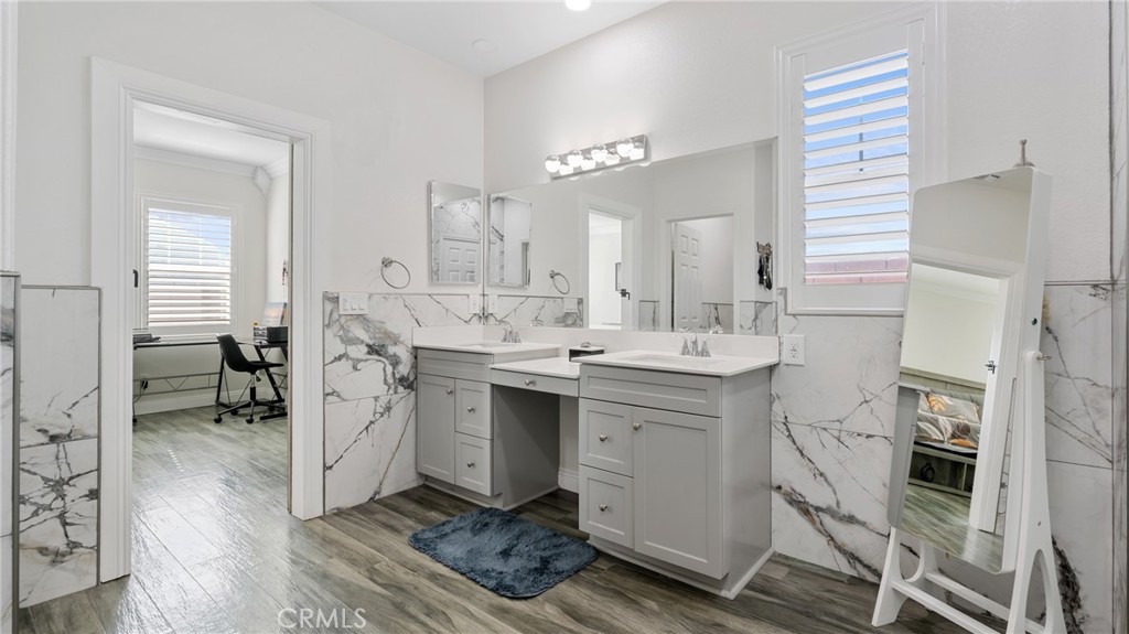 19743 Clementine Court Riverside, CA 92507 - Photo 18 of 31 a spacious bathroom with a double vanity sink a mirror and a shower