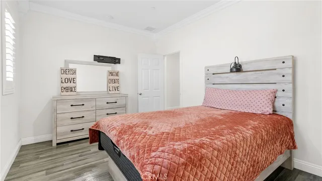 a bedroom with a bed and a dresser