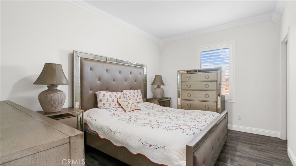 19743 Clementine Court Riverside, CA 92507 - Photo 21 of 31 a bedroom with a bed and wooden floor