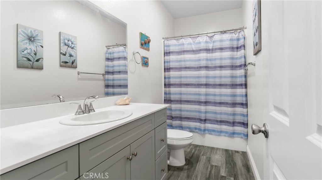 19743 Clementine Court Riverside, CA 92507 - Photo 22 of 31 a bathroom with a sink a toilet and shower curtain