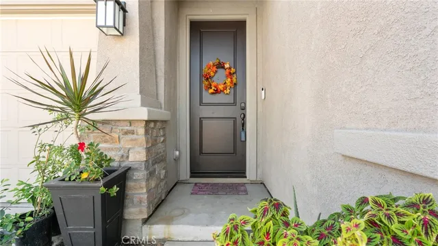 a front view of a house with a flower garden