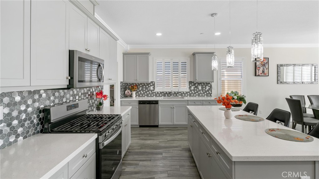 19743 Clementine Court Riverside, CA 92507 - Photo 5 of 31 a kitchen with sink a stove and cabinets