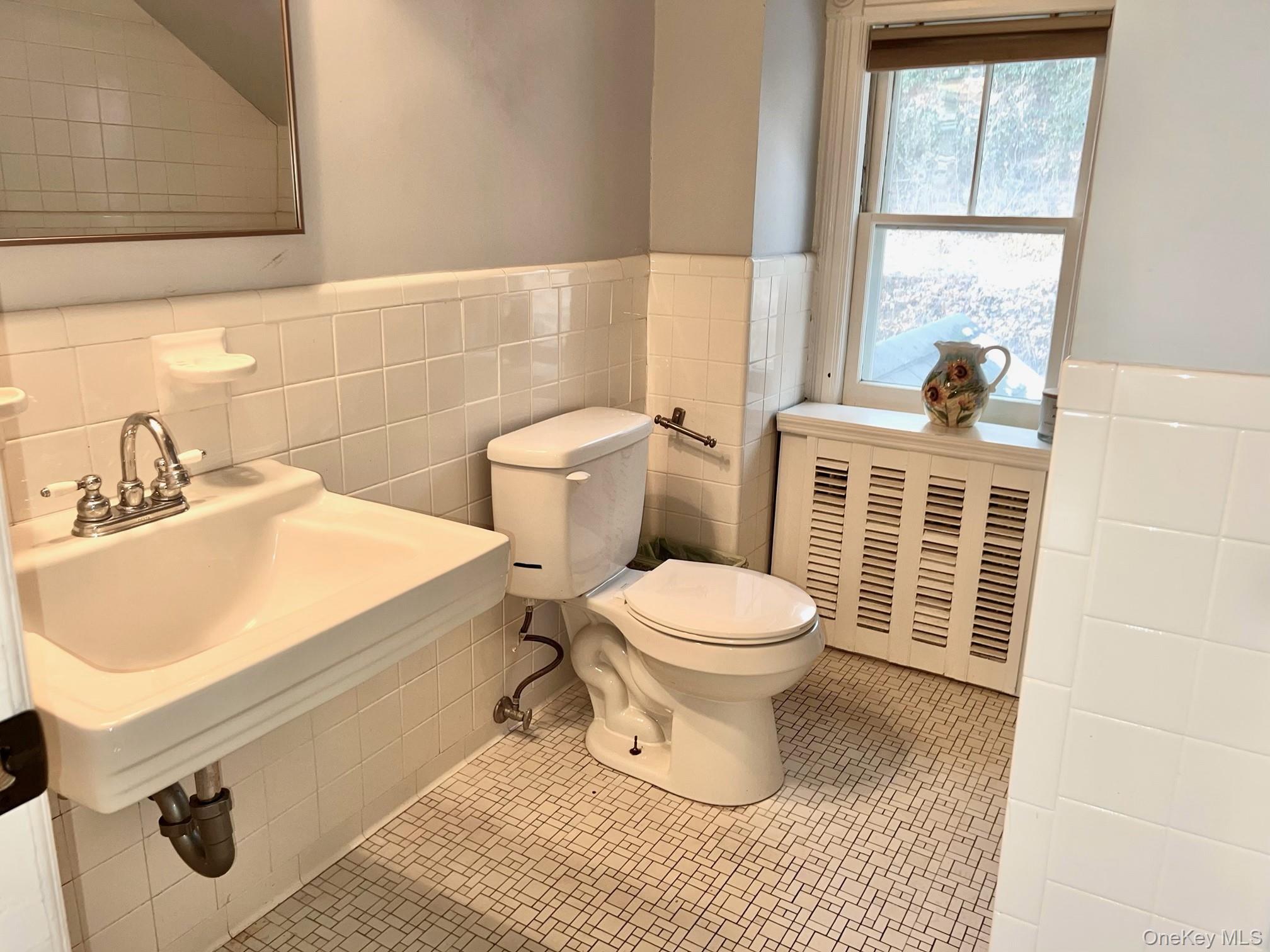 67 River Road Nyack, NY 10960 - Photo 30 of 47 a bathroom with a toilet a sink and a window