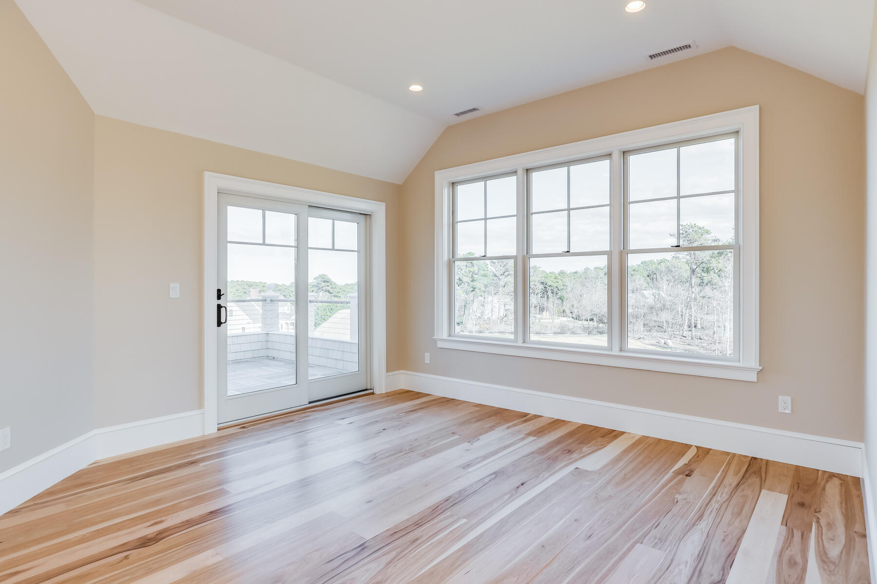 14 Pond View Lane Chatham, MA 02633 - Photo 22 of 30 an empty room with wooden floor and windows