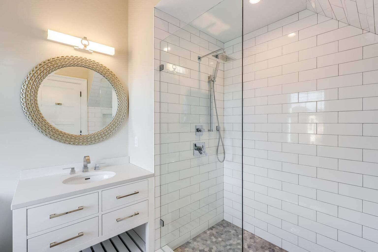 14 Pond View Lane Chatham, MA 02633 - Photo 23 of 30 a bathroom with a sink a toilet a mirror and shower