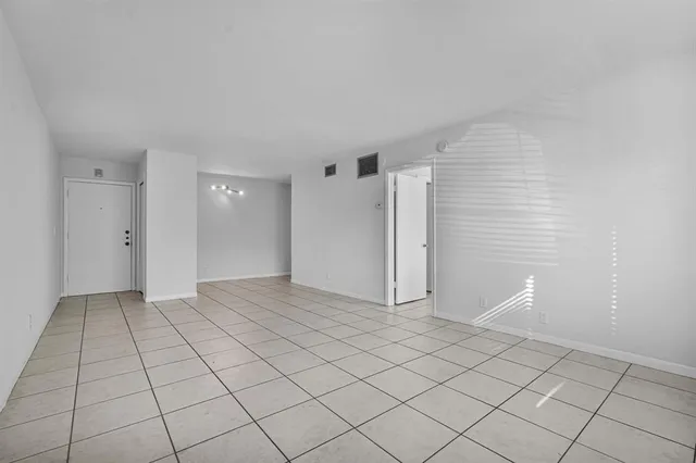 a view of an empty room and entryway