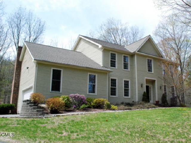 18 Hop Brook Road Brookfield, CT 06804 - Photo 1 of 1 a front view of a house with a garden and yard