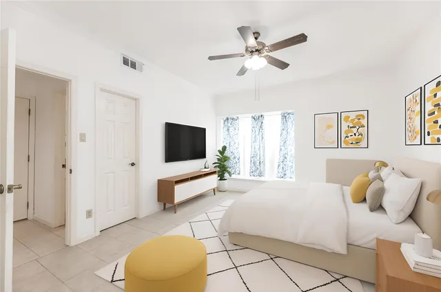 a bedroom with a bed and a flat screen tv