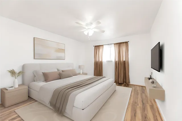 a bedroom with a bed and a flat screen tv