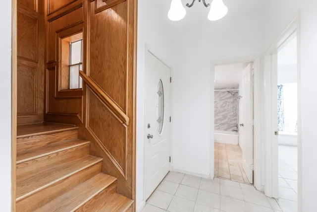 a view of an entryway with wooden floor and door