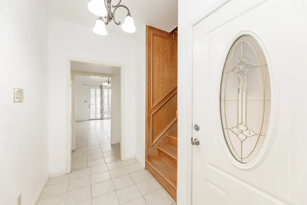 a view of a livingroom with wooden floor and a white door