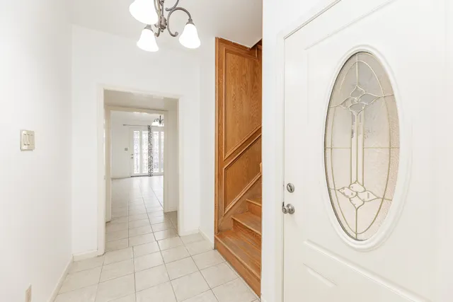 a view of a livingroom with wooden floor and a white door