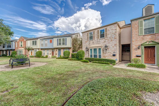a front view of a house with a yard and porch