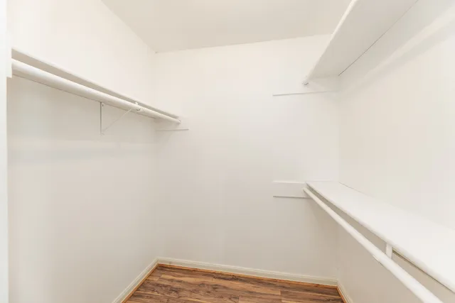 a spacious bathroom with a granite countertop sink and a mirror