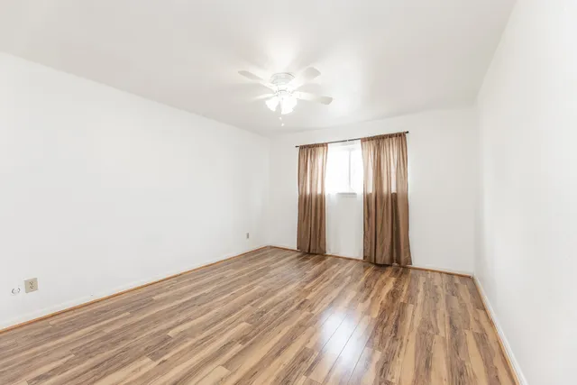 a bathroom with a granite countertop sink a toilet and bathtub