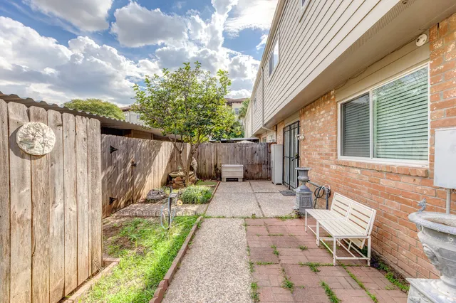 a view of a chairs and table in backyard of the house